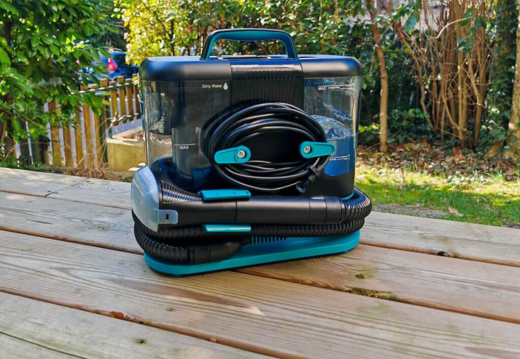Le nettoyeur injecteur-extracteur Rowenta Clean It posé sur une table en bois avec son tuyau et son cordon enroulés