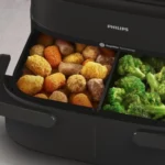 Philips Air Fryer Série 1000 en gros plan avec son tiroir ouvert et ses deux compartiments en cuisson.