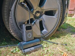 Le compresseur Xiaomi Mi Air Pump Compressor 2 Pro gonfle le pneu avant gauche d’une Tesla Model 3.