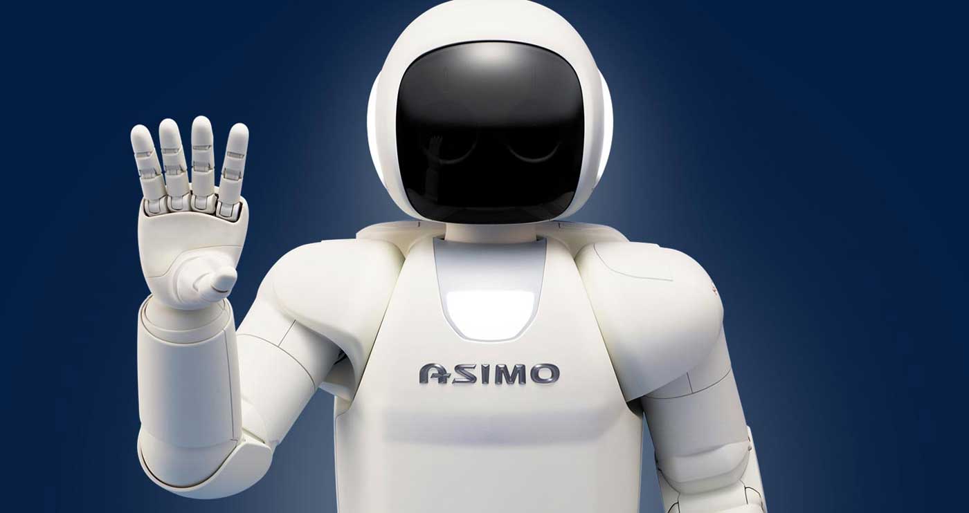 Le robot Honda Asimo fait un salut, démontrant ses compétences en interaction sociale.