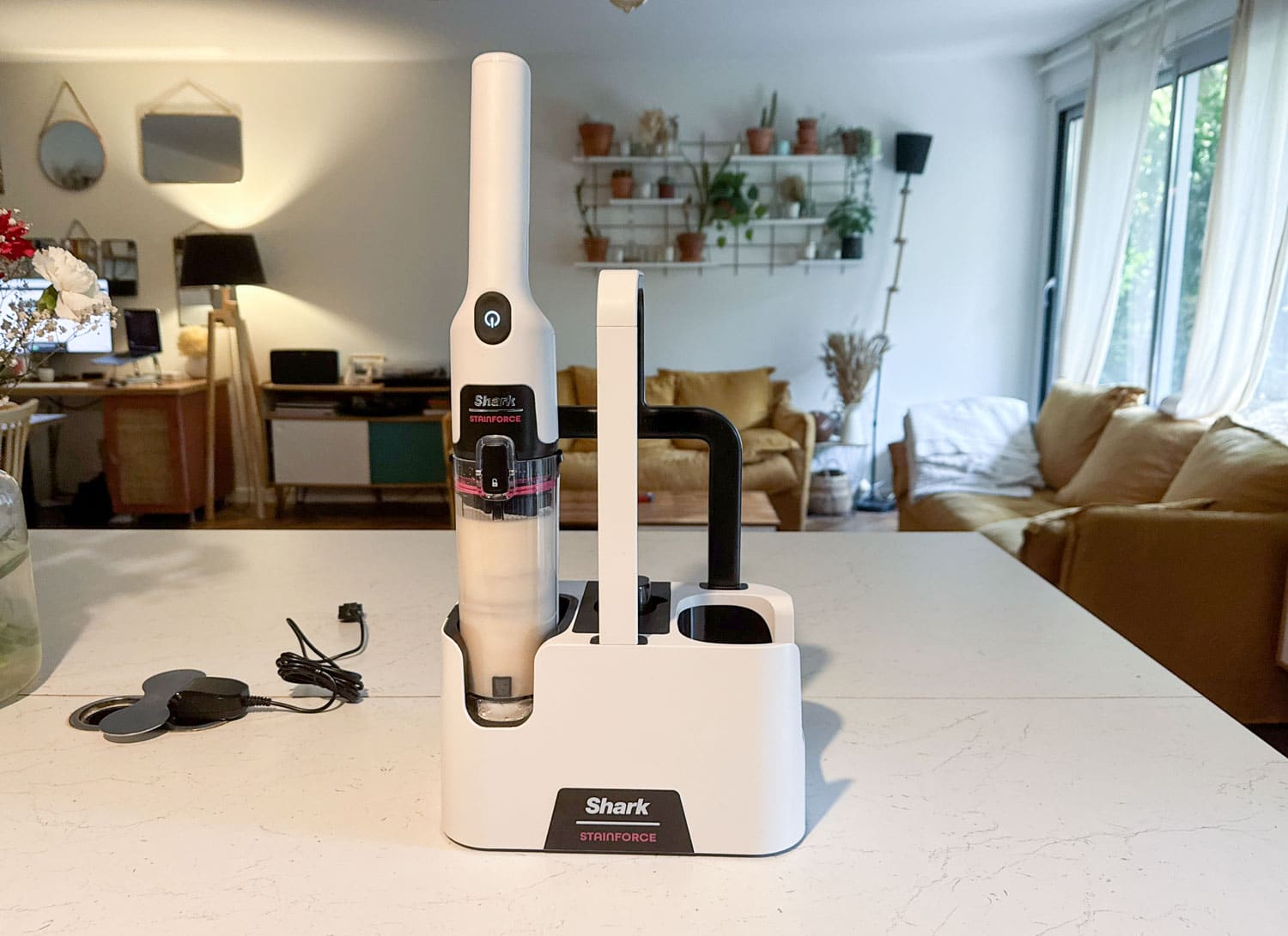 : Fonction d’auto-nettoyage du Shark StainForce HX100EUT sur sa base avec réservoir d’eau