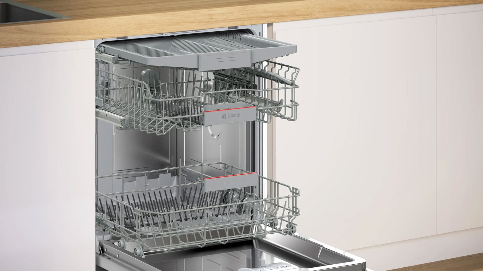 Intérieur du lave-vaisselle Bosch SMV4HVX14E porte ouverte, vue sur les paniers VarioFlex et le tiroir à couverts.