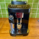 Machine à café à grain Delonghi Magnifica Evo Next sur un plan de travail de cuisine
