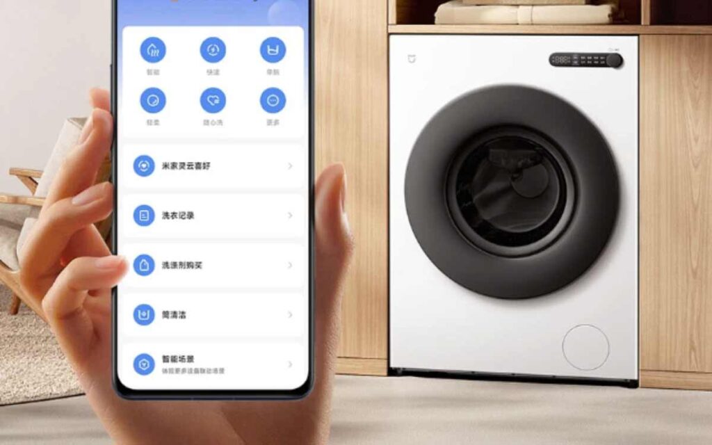 Smartphone affichant l'interface de l'application HyperOS Connect pour contrôler à distance le lave-linge intelligent Xiaomi Mijia blanc.