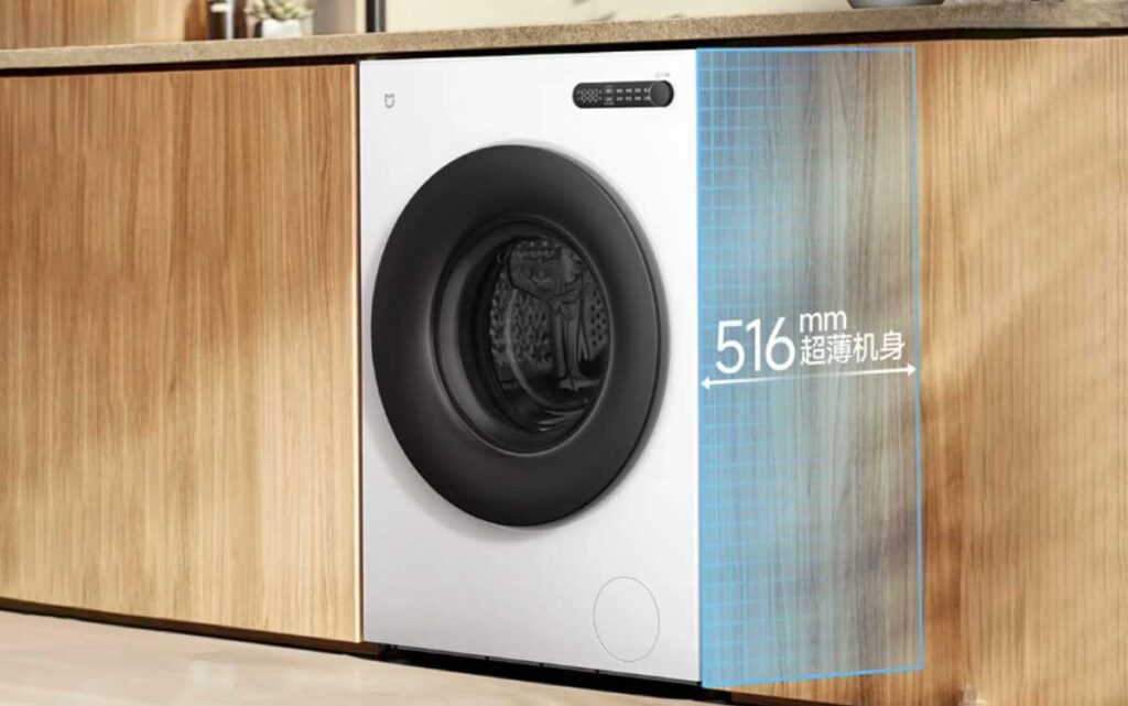Vue de trois-quarts d'un lave-linge blanc Xiaomi Mijia encastré, avec des lignes de cotation rouges indiquant une profondeur de 516 mm dans un meuble de 600 mm.
