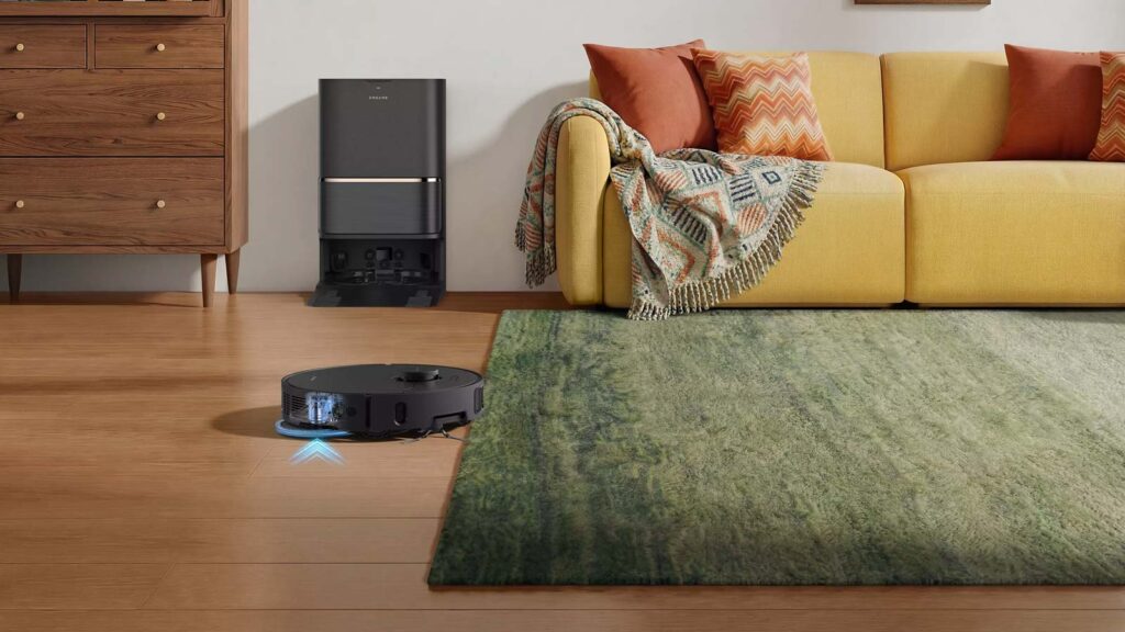 Robot aspirateur laveur Dreame L50 Ultra AE relevant automatiquement ses serpillières de 9 mm avant de monter sur un tapis