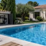 Piscine extérieure d’une maison avec local technique de filtration visible sur le côté