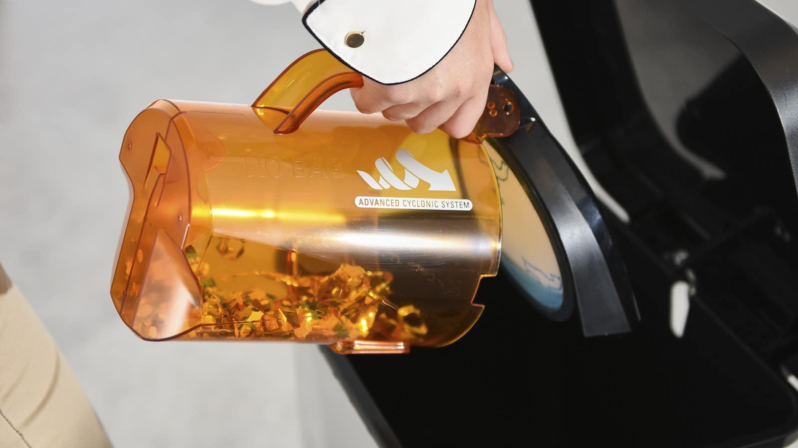 Vidage du bac à poussière orange du Rowenta Compact Power Cyclonic dans une poubelle
